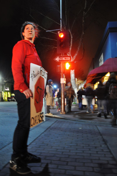Student holds up stop sign for march