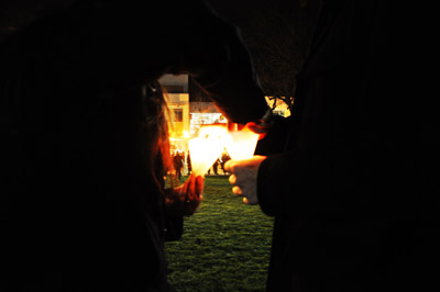 close up of hands lighting candle